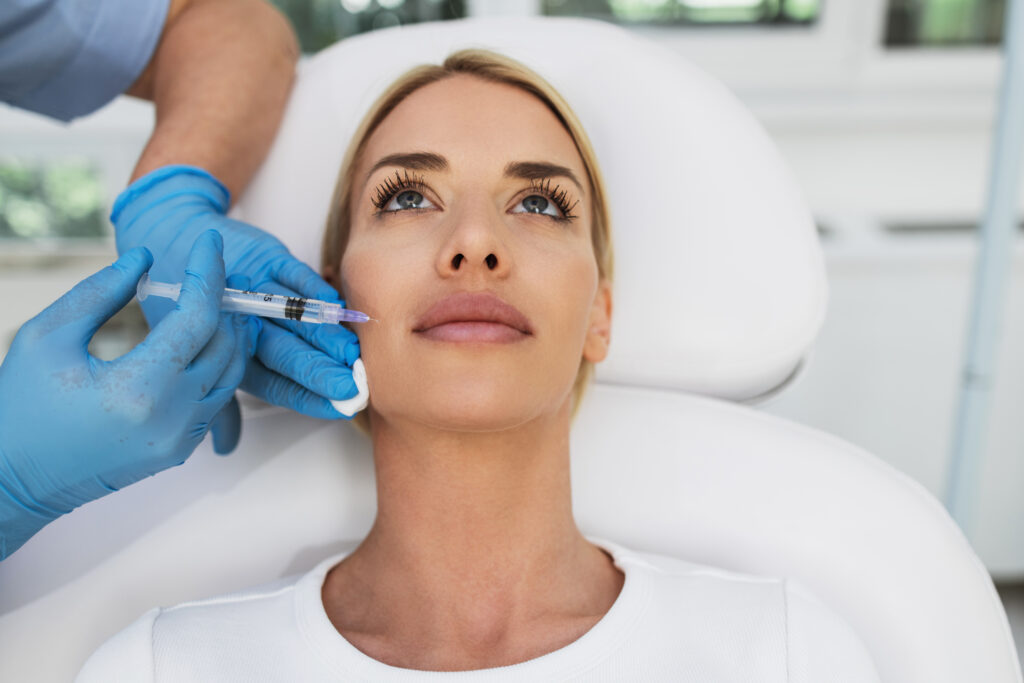 Attractive blond woman is getting a rejuvenating facial injectio